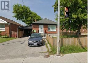 Toronto (Wexford-Maryvale) apartment for rent - A car is parked in front of a brick house.