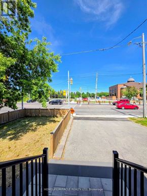 Toronto (Wexford-Maryvale) apartment for rent - A red car is parked on the street in front of a building.