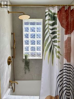 Toronto (South Riverdale) apartment for rent - A bathroom with a shower curtain featuring a zebra print design.