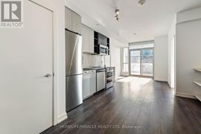 Toronto (York University Heights) condo for rent - A kitchen with stainless steel appliances and wooden floors.