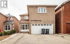 Mississauga (Hurontario) apartment for rent - A brick house with a white garage door is for sale.