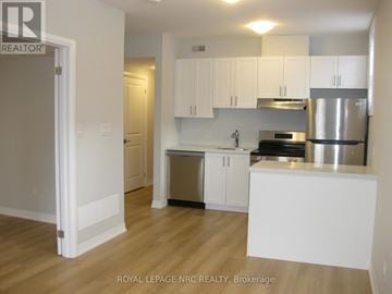 Niagara Falls (Morrison) house for rent - A kitchen with white cabinets and a stainless steel dishwasher.