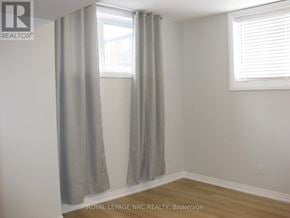 Niagara Falls (Morrison) house for rent - A room with a window and a curtain.