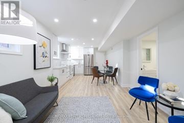 Mississauga (Rathwood) apartment for rent - A living room with a grey couch and a blue chair.