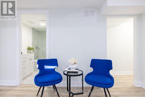 Mississauga (Rathwood) apartment for rent - Two blue chairs are placed in a room with a small table between them.