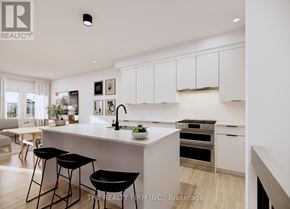 London South (South U) townhouse for rent - A modern kitchen with white cabinets and black bar stools.
