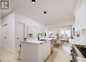 London South (South U) townhouse for rent - A modern kitchen with white cabinets and a central island.