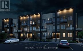 London South (South U) townhouse for rent - A modern apartment building with cars parked in front and the logo of The Realty Firm Inc. on the top left.
