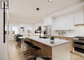 London South (South U) townhouse for rent - A modern kitchen with a large island and stainless steel appliances.
