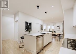 London South (South U) townhouse for rent - A modern kitchen with white cabinets and a wooden floor.