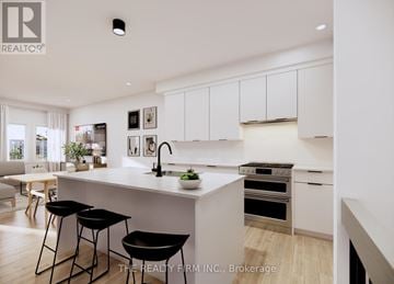 London South (South U) townhouse for rent - A modern kitchen with white cabinets and black bar stools.