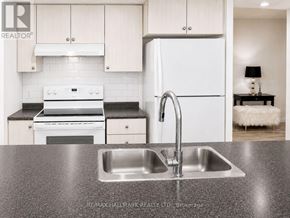 Toronto (Eglinton East) condo for rent - A modern kitchen with a sink and a refrigerator.