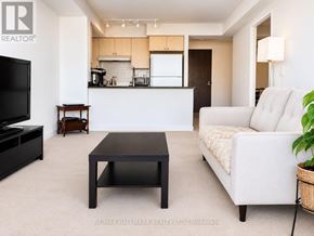 Toronto (Eglinton East) condo for rent - A living room with a white couch and a black coffee table.