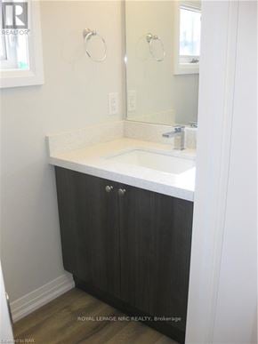 Niagara Falls (Morrison) townhouse for rent - A white sink in a bathroom with a black cabinet.