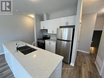 Niagara Falls (Morrison) townhouse for rent - A kitchen with white cabinets and a granite countertop.