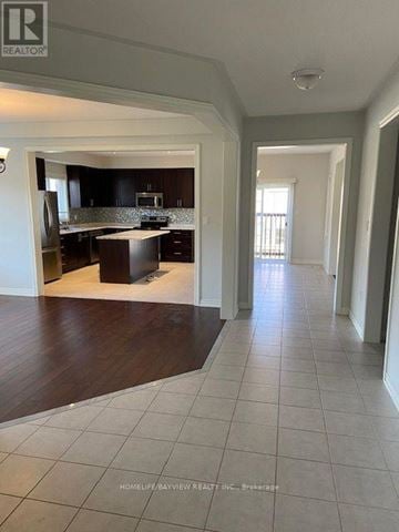 Georgina (Keswick South) apartment for rent - A spacious kitchen with dark wood cabinets and a white island.