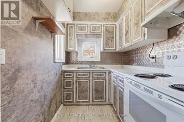 Hamilton (Crown Point) apartment for rent - A kitchen with a white stove top oven and a tiled backsplash.