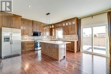 Oakville (Jc Joshua Creek) apartment for rent - A kitchen with wooden cabinets and a marble countertop.