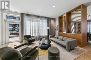 Mississauga (Central Erin Mills) condo for rent - A living room with a grey sofa and a wooden slatted wall.