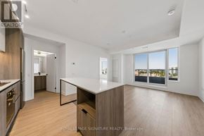Mississauga (Central Erin Mills) condo for rent - A spacious kitchen with wooden floors and white countertops.