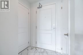 Hamilton (Stoney Creek) condo for rent - A white door with a silver handle is in the middle of a white hallway.