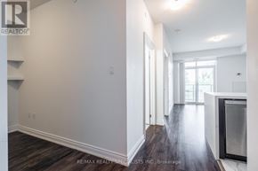 Hamilton (Stoney Creek) condo for rent - A spacious room with wood flooring and white walls.