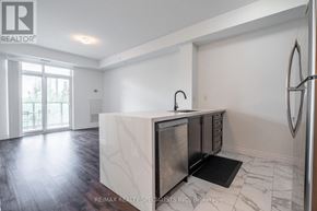 Hamilton (Stoney Creek) condo for rent - A modern kitchen with a marble island and stainless steel appliances.