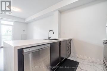 Hamilton (Stoney Creek) condo for rent - A modern kitchen with a stainless steel dishwasher and white countertops.