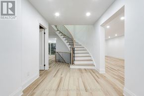 Mississauga (Sheridan) apartment for rent - A white interior with a staircase and a brokerage logo.