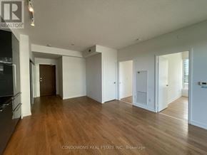 Toronto (Bayview Village) condo for rent - A spacious room with wooden flooring and white walls, part of a property managed by Condowong Real Estate Inc.