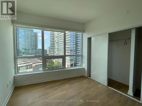 Toronto (Bayview Village) condo for rent - A room with a large window overlooking a cityscape.