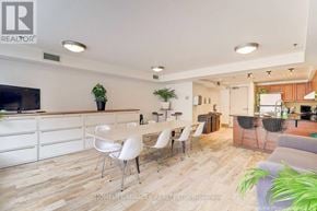 Toronto (Cabbagetown-South St. James Town) condo for rent - A well-lit, spacious kitchen and dining area with white chairs and a wooden floor.