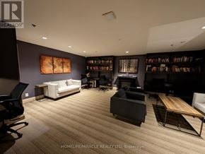 Toronto (Cabbagetown-South St. James Town) condo for rent - A living room with a white couch and a wooden floor.