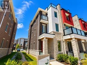 Pickering townhouse for rent - A modern apartment building with a mix of brick and stone facades.