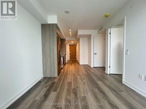 Vaughan (Concord) condo for rent - A long hallway with wood floors and white walls.