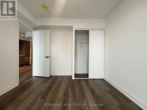 Vaughan (Concord) condo for rent - A room with wood flooring and white walls, with a door on the left and a closet on the right.