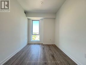 Toronto (Regent Park) condo for rent - A room with wooden floors and a window letting in light.