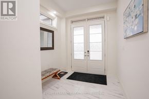 Adjala-Tosorontio (Colgan) apartment for rent - A white door with a glass window is in the middle of a hallway.
