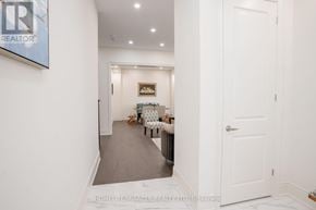 Adjala-Tosorontio (Colgan) apartment for rent - A hallway with a white door and a sign that says "REALTOR".