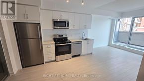 Toronto (Humber Heights) condo for rent - A modern kitchen with stainless steel appliances and white cabinets.