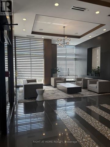 Markham (Wismer) condo for rent - A modern living room with a glass floor and a chandelier.