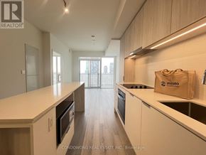 Toronto (Church-Yonge Corridor) condo for rent - A kitchen with white countertops and wooden cabinets.