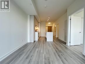 Toronto (Church-Yonge Corridor) condo for rent - A spacious room with wood flooring and white walls.