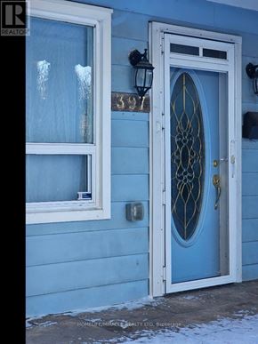 Toronto (Clairlea-Birchmount) apartment for rent - A blue house with a white door and window.