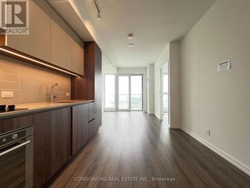Vaughan (Vaughan Corporate Centre) condo for rent - A modern kitchen with dark wood floors and a stainless steel stove.