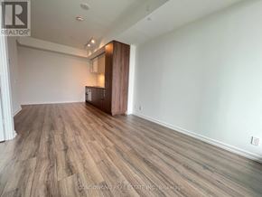 Vaughan (Vaughan Corporate Centre) condo for rent - A room with wood flooring and a white wall.