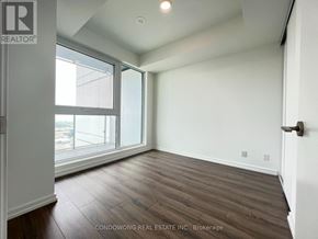 Vaughan (Vaughan Corporate Centre) condo for rent - A room with wood flooring and a large window.