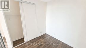 Vaughan (Vaughan Corporate Centre) condo for rent - A room with a sliding door and wooden flooring.