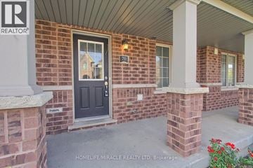 Cambridge townhouse for rent - A brick house with a black door and a sign that says "Parking".