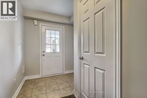 Cambridge townhouse for rent - A white door is open to a room with a tiled floor.